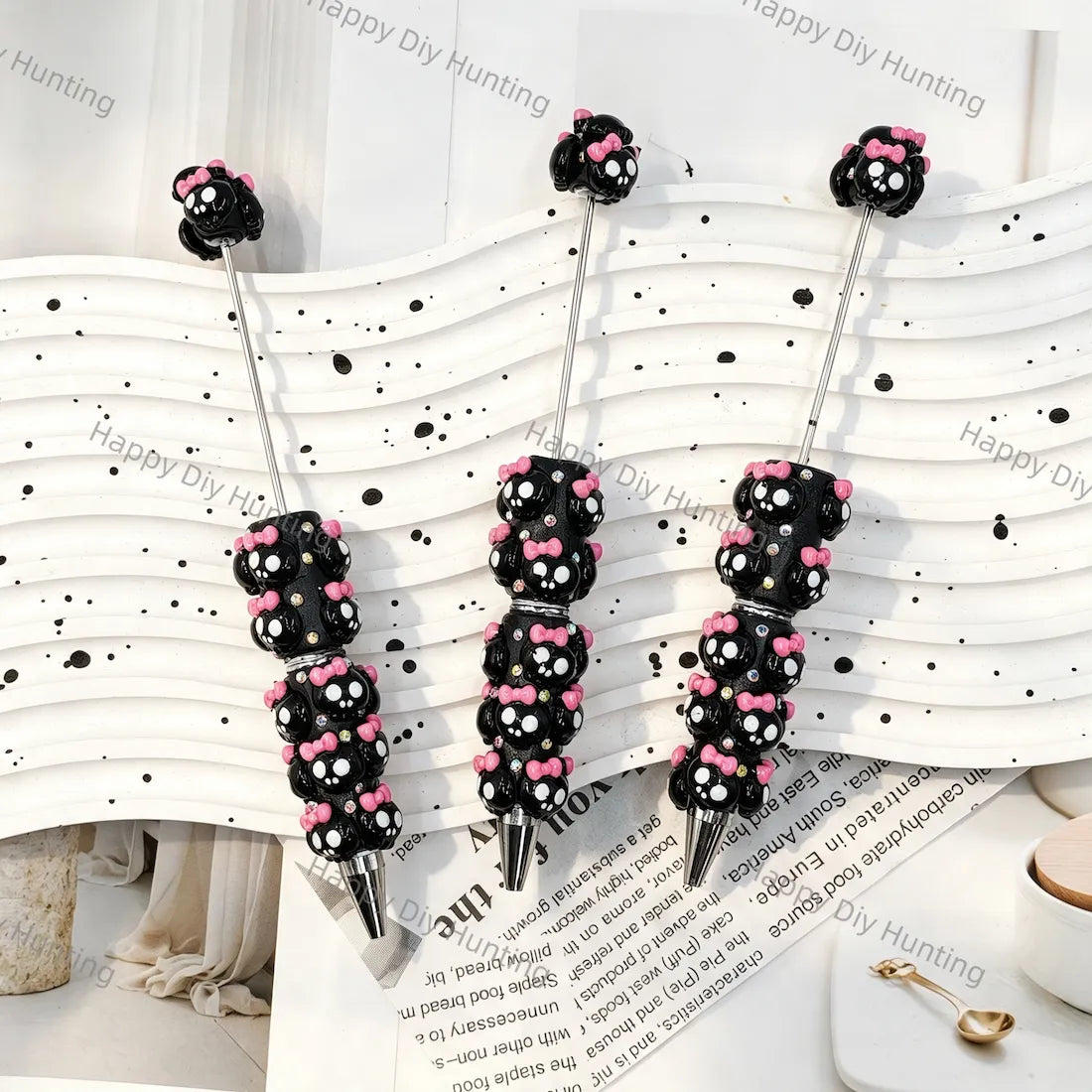 black 3d cute round face character beadable pens with pink bow and rhinestone accents for diy handmade kawaii stationery crafts wholesale