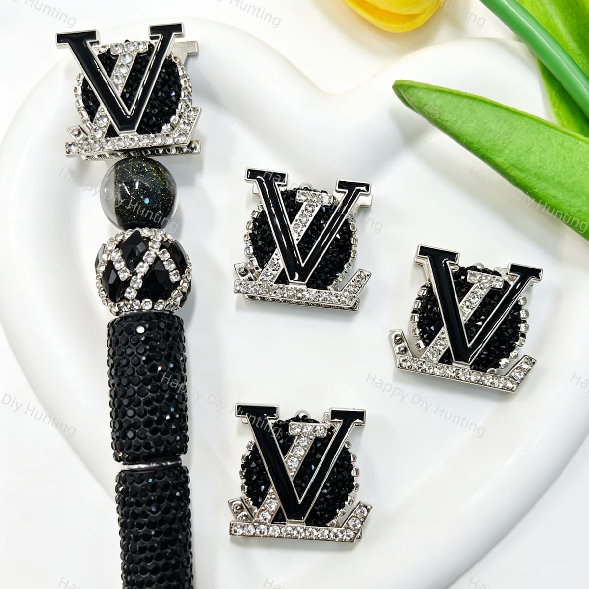 Black metal fancy beads featuring a designer V*L letter design with a rhinestone border, displayed with a black rhinestone beadable pen. Sturdy, shiny, and glamorous, perfect for beadable pens, keychains, and handmade crafts.