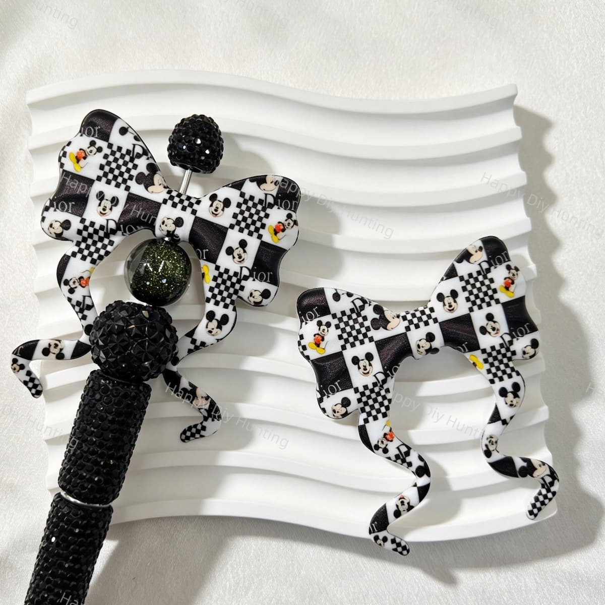 Bow-shaped silicone focal beads featuring a black and white checkered cartoon mouse print design. Soft, durable, and flexible, perfect for beadable pens, keychains, and handmade crafts.