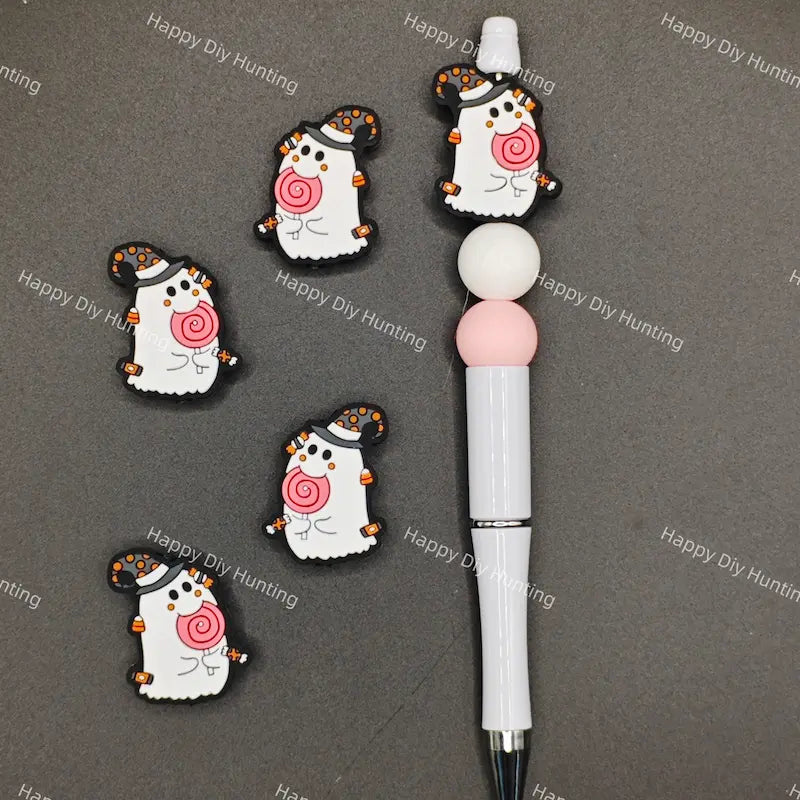 Halloween cartoon ghost silicone focal beads wearing polka dot witch hat and holding pink lollipop, match spacer beads for DIY handmade beadable pen holiday crafts.