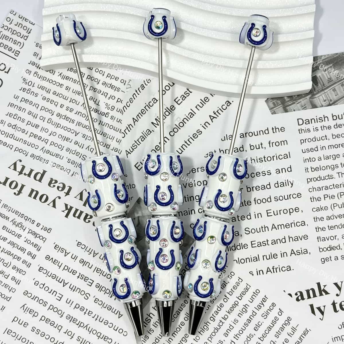 close-up blue-white horseshoe IC football print bow bead showing team spirit design