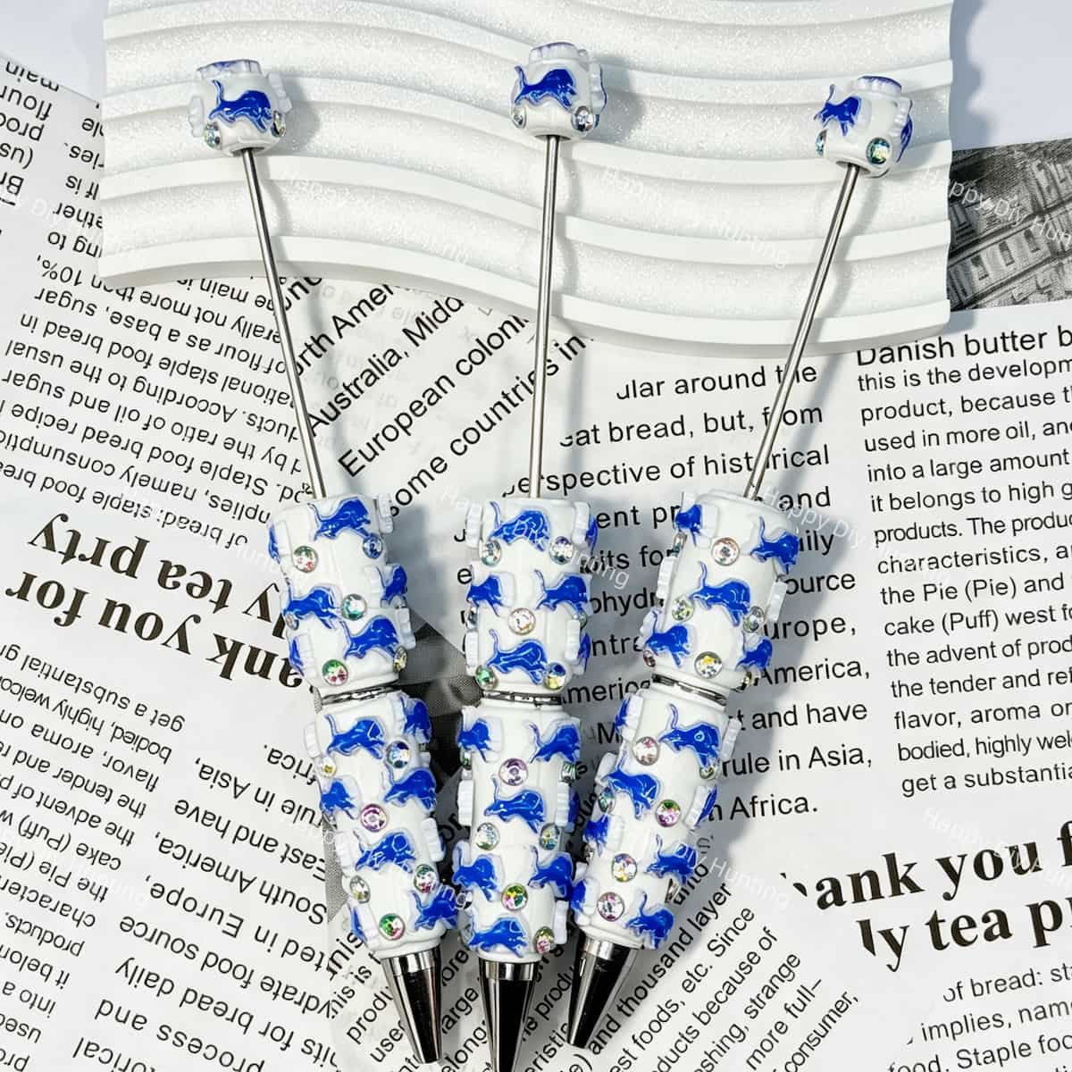 close-up blue wild-lion DL football beadable pen showing lion design and beadable barrel