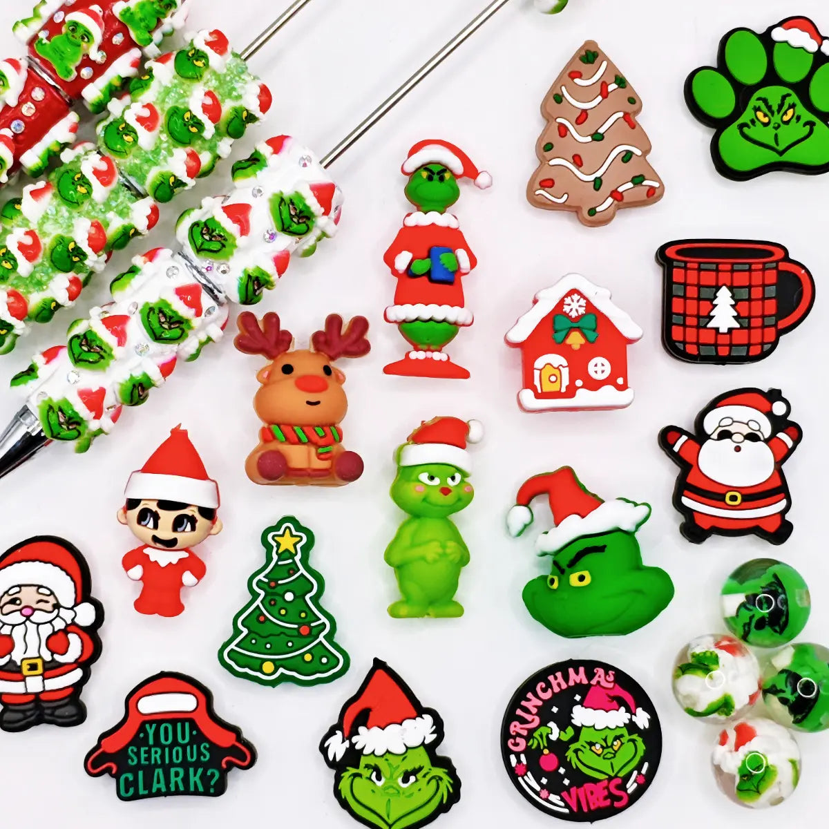 Christmas craft supplies collection with festive silicone focal beads, acrylic beads, toppers, and beaded pens.