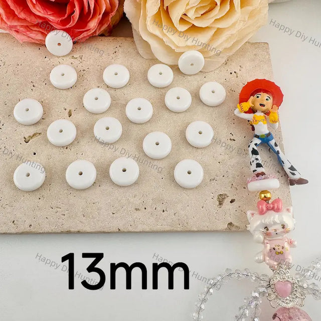 13mm solid white flat disc resin spacer beads with small central through hole, solid matte white resin material for layering DIY beadable pens, bag charms and handmade jewelry craft accessories.