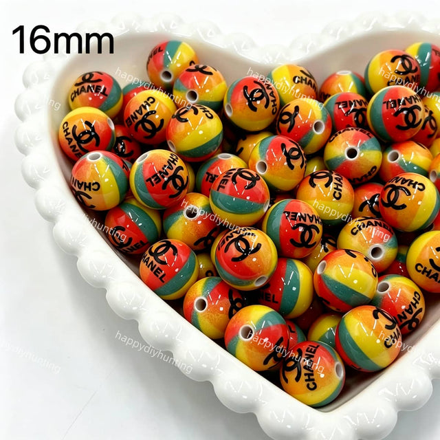 close-up 16mm designer CC rainbow striped acrylic bead showing colorful stripe design
