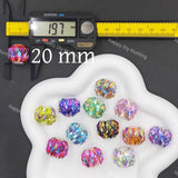 Twelve faceted round craft beads in various iridescent colors, displayed on a white cloud-shaped tray. A digital caliper is shown on the left measuring one bead to 19.