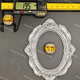 A rectangular yellow crystal bead with a silver-toned border and clear rhinestone accents, displayed on a gray background with a decorative silver frame and a caliper showing 19.5 mm measurement.