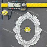A small oval ring with a yellow center and clear surrounding stones is shown on a dark gray surface, alongside a silver ornate frame, a digital caliper reading 19.7 mm, and repeated Happy DIY Hunting watermarks.