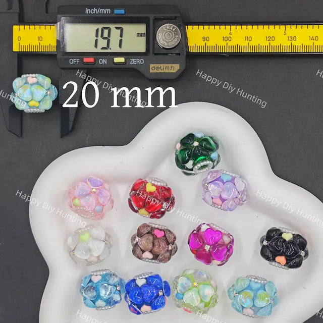 A set of colorful glass bead hunting beads displayed on a white cloud-shaped tray, with a digital caliper showing 20 mm size and a yellow inch-to-cm ruler above. 