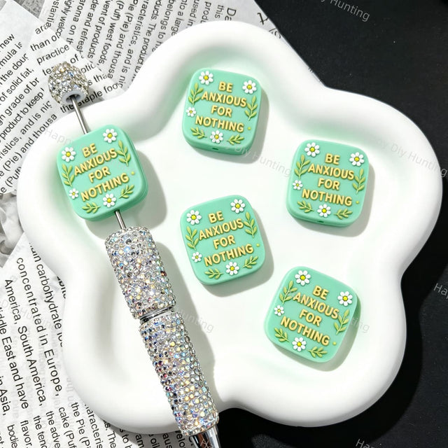 Silicone focal beads featuring a "Be Anxious For Nothing" inspirational message and square graphic design. Soft, durable, and flexible, perfect for beadable pens, keychains, and handmade crafts.