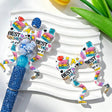 Silicone bow beads featuring a "Best Teacher" print with book, pencil, and flower designs. Soft, durable, and flexible, perfect for beadable pens, keychains, and handmade crafts.