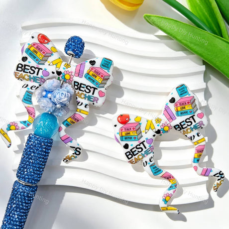 Silicone bow beads featuring a "Best Teacher" print with book, pencil, and flower designs. Soft, durable, and flexible, perfect for beadable pens, keychains, and handmade crafts.