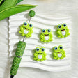 Silicone focal beads featuring a big-eyed green frog cartoon design. Soft, durable, and flexible, perfect for beadable pens, keychains, and handmade crafts.