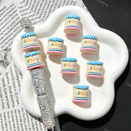 Silicone focal beads featuring a birthday cake shape with colorful layered details. Soft, durable, and flexible, perfect for beadable pens, keychains, and handmade crafts.