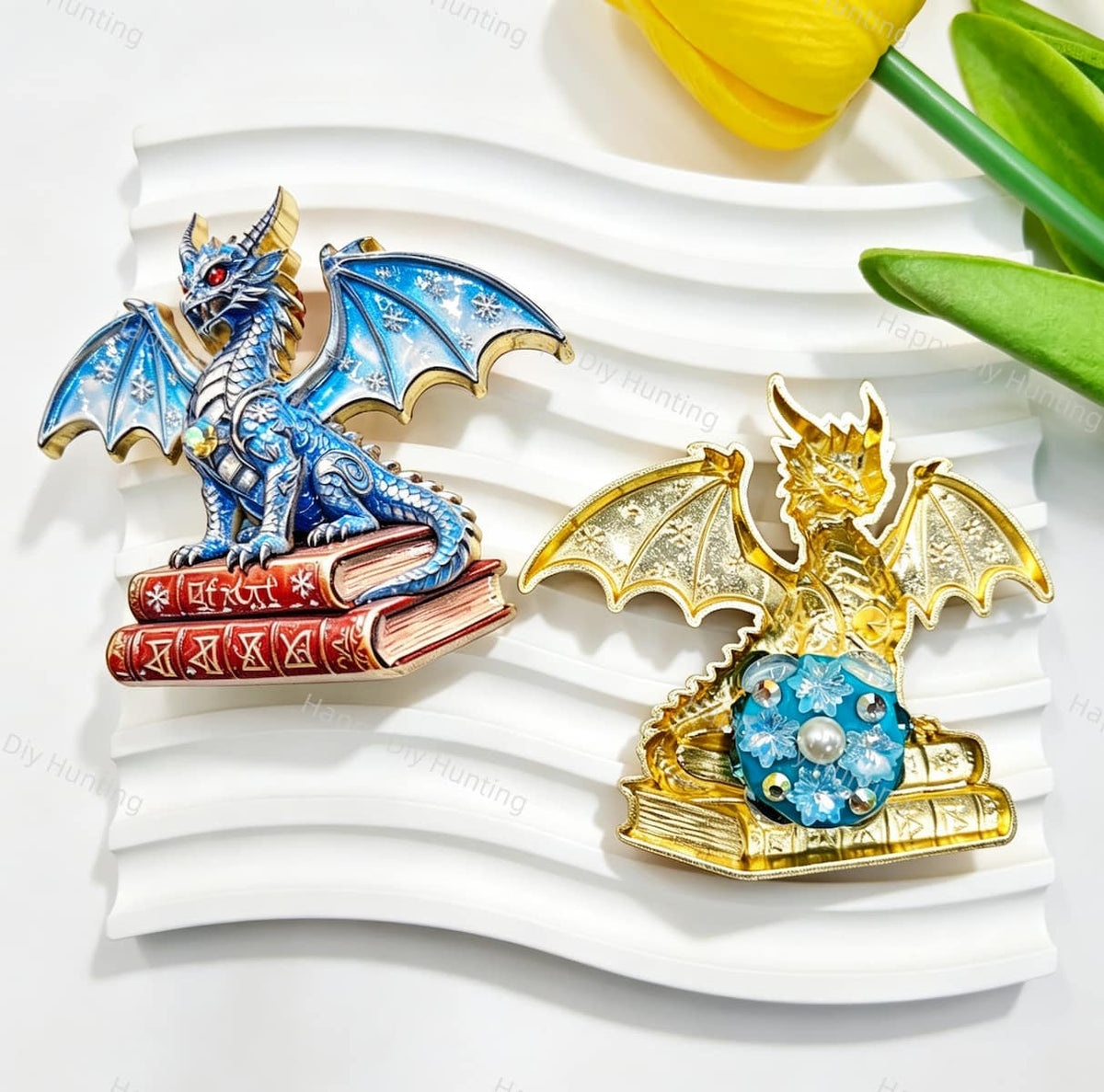 Blue book winged dragon metal fancy bead with rhinestones shown from the front and back. The front features a detailed blue dragon with enamel wings sitting on red books, while the back shows a gold metal finish. Perfect for DIY beadable pens and crafts.