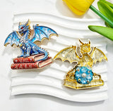 Blue book winged dragon metal fancy bead with rhinestones shown from the front and back. The front features a detailed blue dragon with enamel wings sitting on red books, while the back shows a gold metal finish. Perfect for DIY beadable pens and crafts.