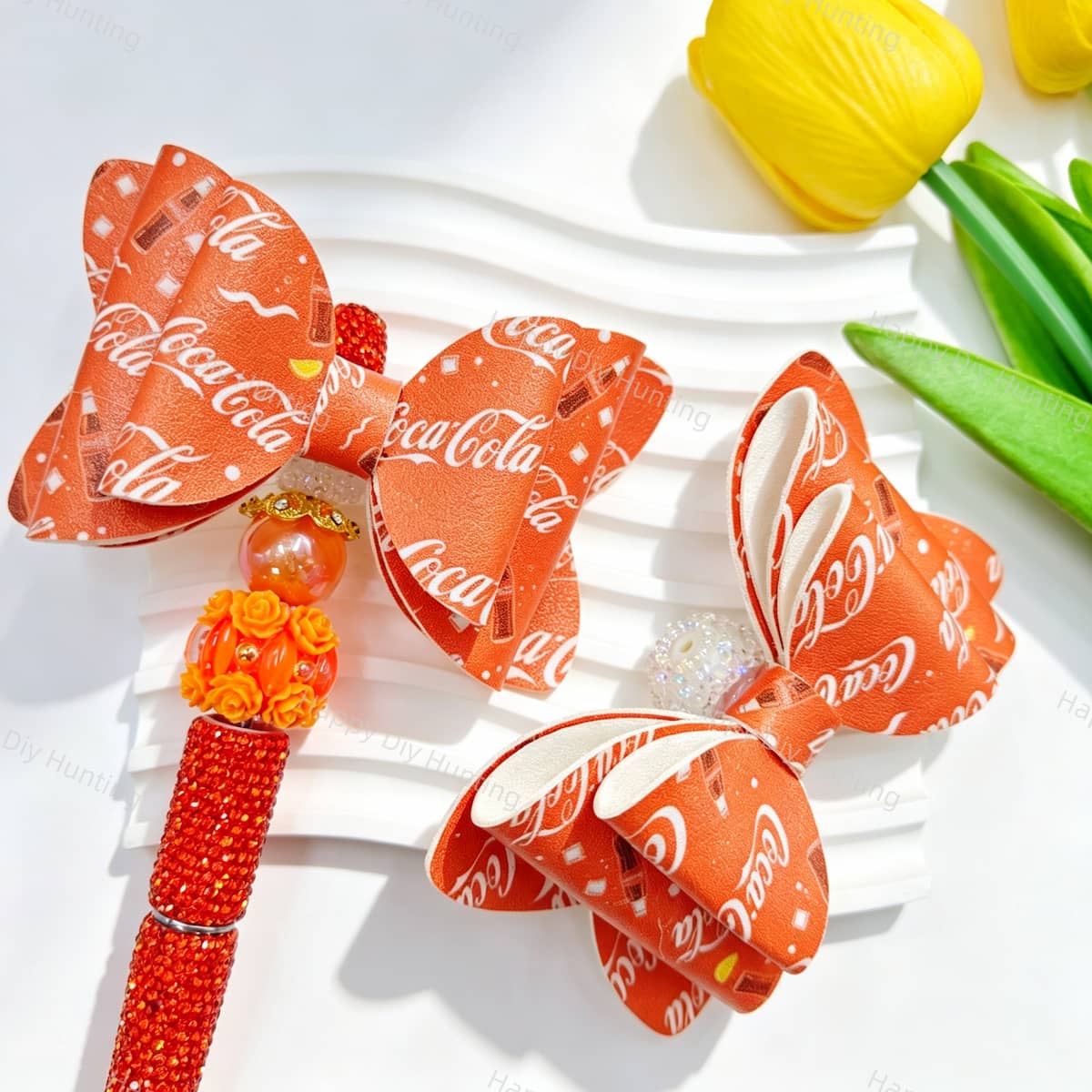 Bow-shaped focal beads featuring a bright red classic cola style print design. Sturdy, colorful, and easy to customize, perfect for beadable pens, keychains, and handmade crafts.