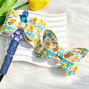 White bow-shaped PU leather focal beads with colorful cartoon bird designs. Perfect for beadable pens, keychains, and handmade crafts.