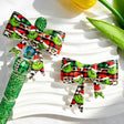 Bow-shaped silicone focal beads featuring a Christmas green character wearing a Santa hat print design. Soft, durable, and flexible, perfect for beadable pens, keychains, and handmade holiday crafts.