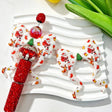 Bow-shaped silicone focal beads featuring a festive Christmas Santa, snowman, and reindeer print design. Soft, durable, and flexible, perfect for beadable pens, keychains, and handmade holiday crafts.