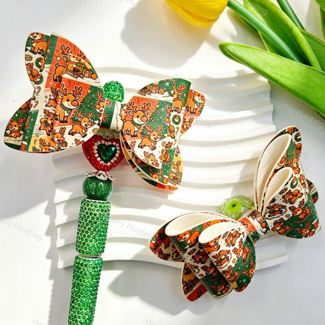 Bow-shaped beads featuring a Christmas reindeer print design. Lightweight, festive, and durable, perfect for beadable pens, keychains, and handmade holiday crafts.