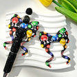 Bow-shaped silicone focal beads featuring a colorful cartoon candy character design. Soft, durable, and flexible, perfect for beadable pens, keychains, and handmade crafts.