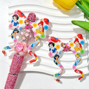 Bow-shaped silicone focal beads featuring a colorful princess cartoon print design. Soft, durable, and flexible, perfect for beadable pens, keychains, and handmade crafts.