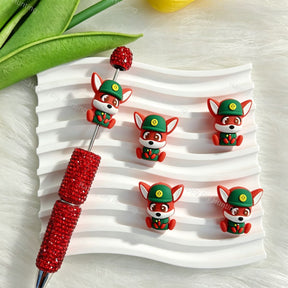 Silicone focal beads featuring a cute red fox wearing a green hat. Soft, durable, and flexible, perfect for beadable pens, keychains, and handmade crafts.
