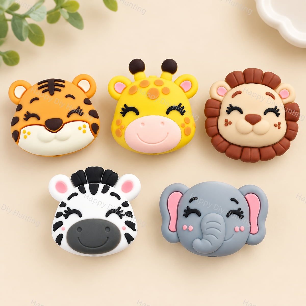 	Flat lay of five cute safari animal silicone focal beads. Designs include a tiger, giraffe, lion, zebra, and elephant, all with closed eyes and sweet smiles. Soft, durable, and perfect for beadable pens, keychains, and handmade crafts.