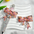 White bow-shaped silicone focal beads with colorful fashion doll collage designs. Shown with a rhinestone beadable pen and a pink round bead. Perfect for beadable pens, keychains, and handmade crafts.
