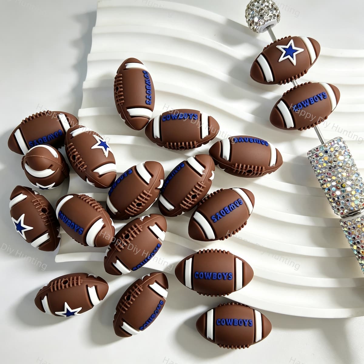 Silicone focal beads featuring a football design with star and letter print details. Soft, durable, and flexible, perfect for beadable pens, keychains, and handmade crafts.