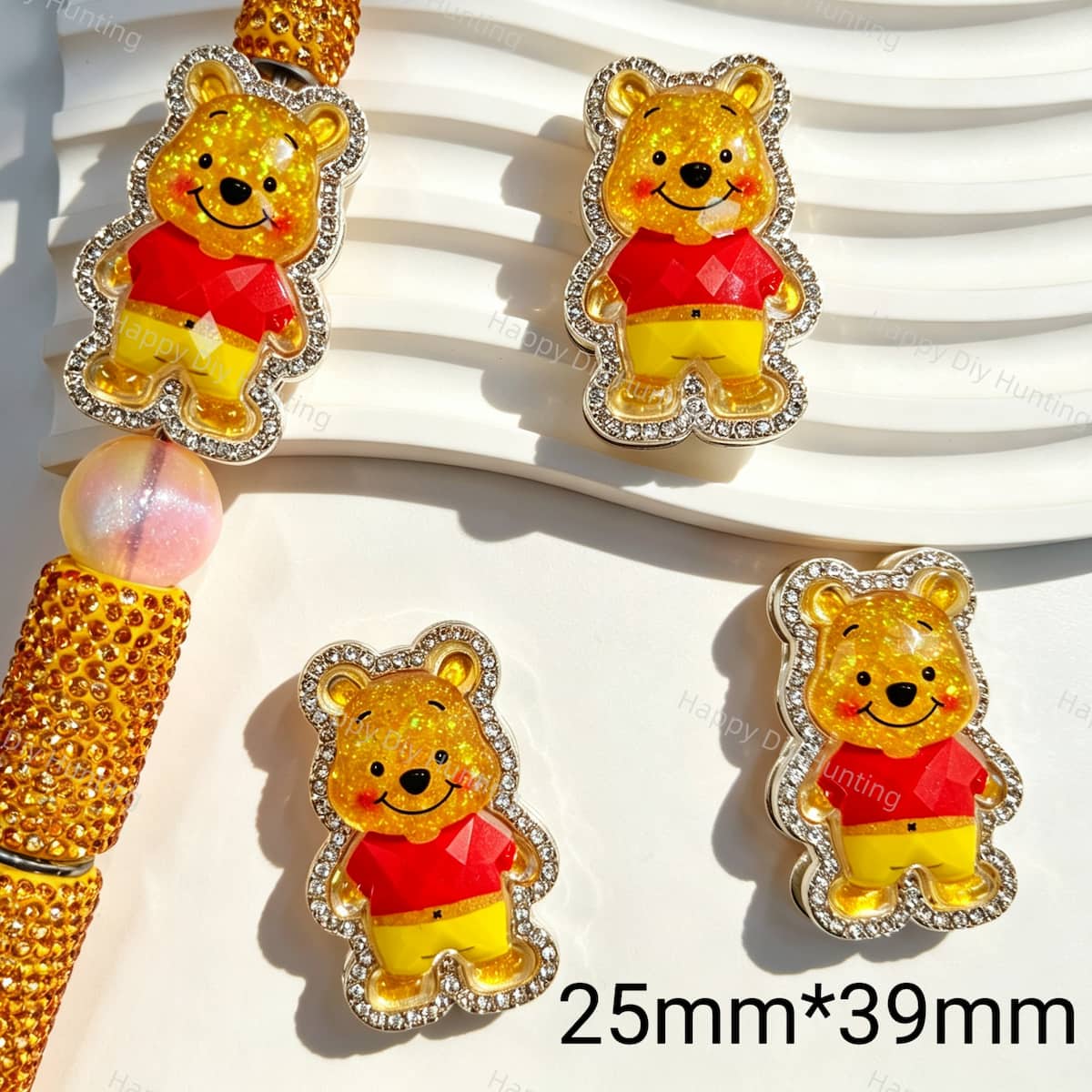 Fancy beads featuring a glitter yellow bear design with a rhinestone border. Sturdy, shiny, and eye-catching, perfect for beadable pens, keychains, and handmade crafts.