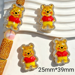 Fancy beads featuring a glitter yellow bear design with a rhinestone border. Sturdy, shiny, and eye-catching, perfect for beadable pens, keychains, and handmade crafts.