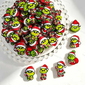 Acrylic focal beads featuring a green Christmas monster character print design. Lightweight, festive, and durable, perfect for beadable pens, keychains, and handmade holiday crafts.