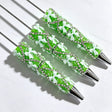 Green beadable pen featuring a decorative bow and sparkling rhinestones. Refillable and customizable, perfect for DIY crafts and handmade gifts.