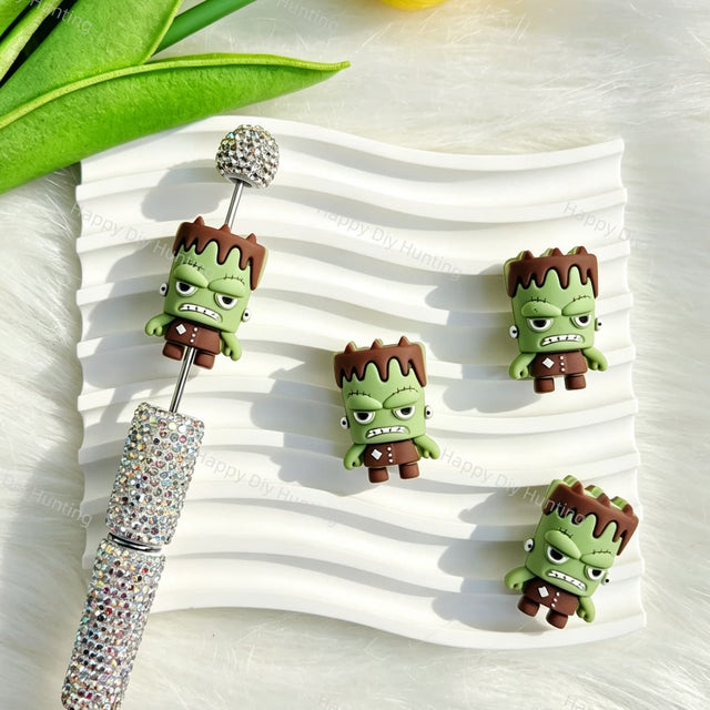 Silicone focal beads featuring a Halloween green monster 3D cartoon design. Soft, durable, and flexible, perfect for beadable pens, keychains, and handmade crafts.