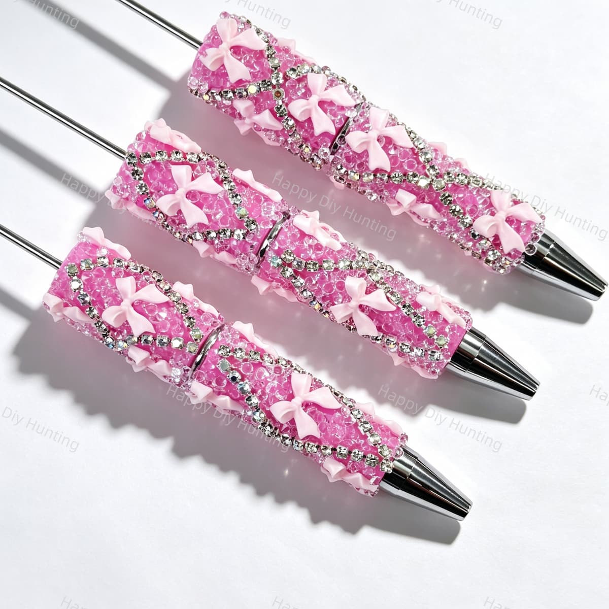 Light pink beadable pen featuring a decorative bow and sparkling rhinestones. Refillable and customizable, perfect for DIY crafts and handmade gifts.