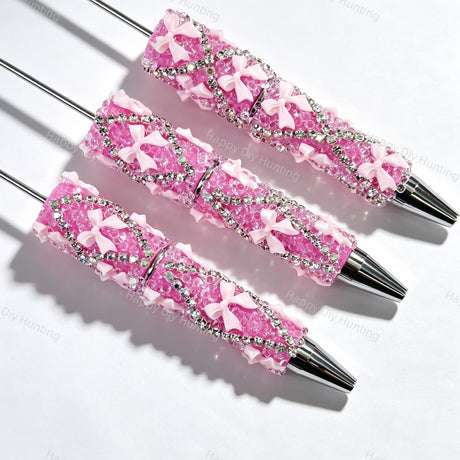 Light pink beadable pen featuring a decorative bow and sparkling rhinestones. Refillable and customizable, perfect for DIY crafts and handmade gifts.