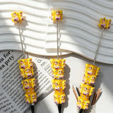 Pre‑assembled beadable pens stacked with long‑blonde‑hair princess figurines. Bright orange base embedded with sparkling rhinestones. Cute themed ballpoint pens for gifts, bulk craft supplies.