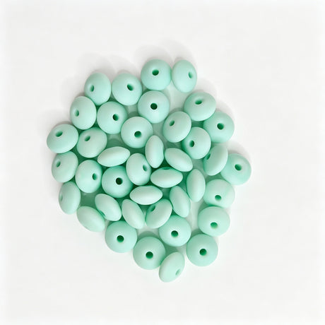 Mint green round acrylic spacer beads. Smooth, lightweight, and colorful, perfect for beadable pens, keychains, and handmade crafts.