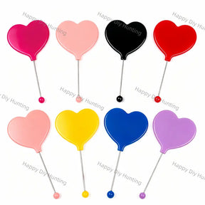 Assorted 8-color heart mini handheld cosmetic mirrors, glossy solid ABS plastic heart shell built-in clear glass makeup mirror, fitted with anti-rust stainless steel thin handle pin, matching colored round ball grip at pin bottom. 