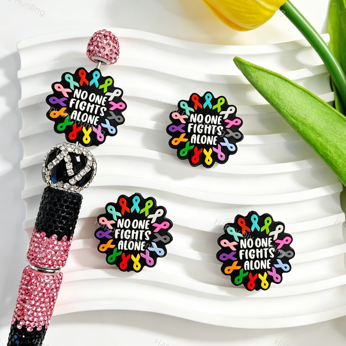 Silicone focal beads featuring a multicolor awareness ribbon and "No One Fights Alone" quote print design. Soft, durable, and flexible, perfect for beadable pens, keychains, and handmade crafts.