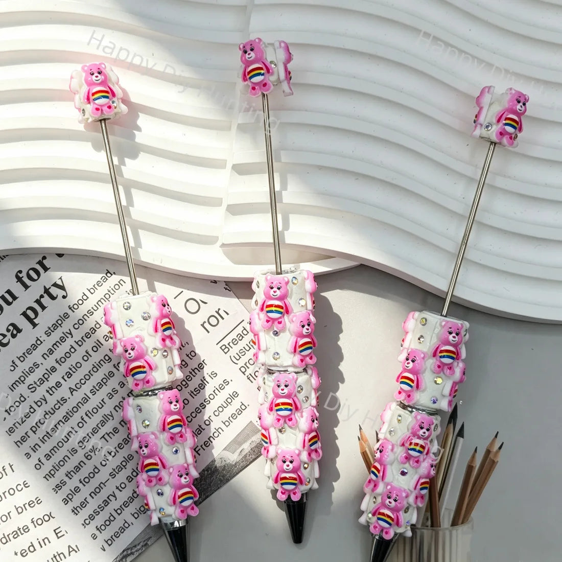 pre‑assembled pink stacked 3D rainbow‑belly bear figurine beadable pens with embedded sparkling rhinestones bulk cute themed craft ballpoint pens