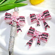Bow-shaped silicone focal beads featuring a pink and black cute slogan text print design. Soft, durable, and flexible, perfect for beadable pens, keychains, and handmade crafts.