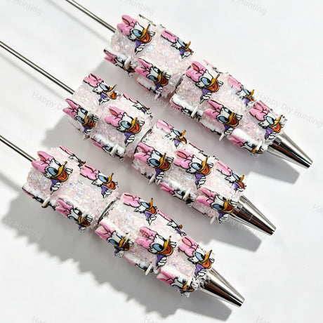 Pink bow cartoon duck character beadable pens. Refillable and customizable, matching all focal beads and pen toppers. Perfect for DIY crafts, handmade gifts, and craft fair retail.