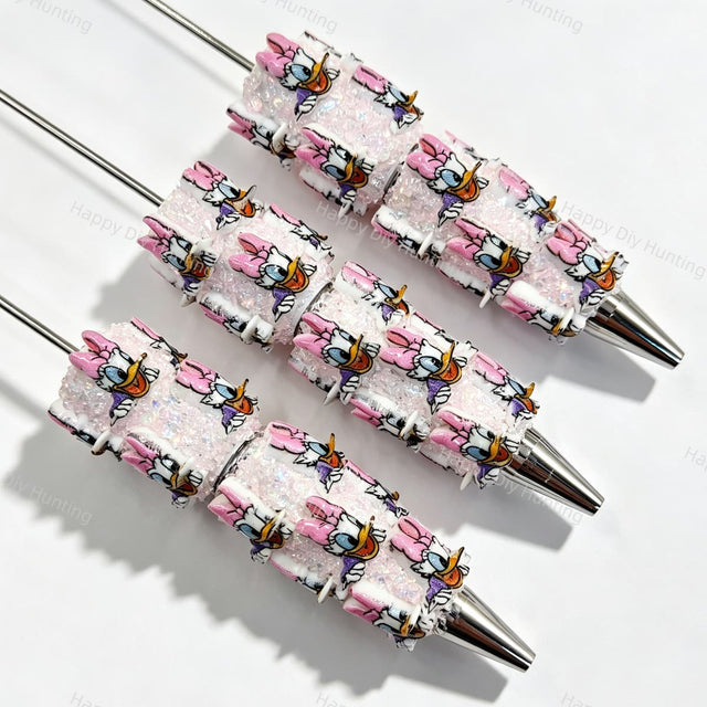 Pink bow cartoon duck character beadable pens. Refillable and customizable, matching all focal beads and pen toppers. Perfect for DIY crafts, handmade gifts, and craft fair retail.