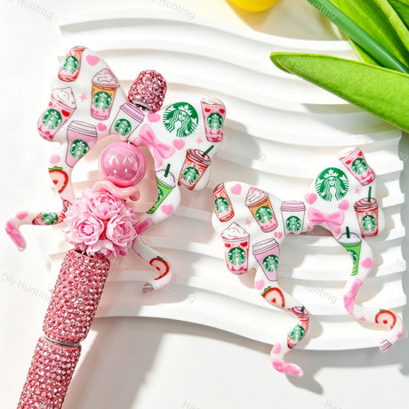 Bow-shaped silicone focal beads featuring a pink coffee cup print design. Soft, durable, and flexible, perfect for beadable pens, keychains, and handmade crafts.