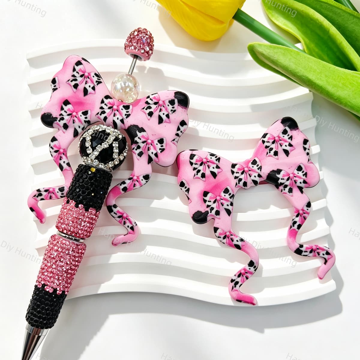 Bow-shaped silicone focal beads featuring a pink cow print pattern. Soft, durable, and flexible, perfect for beadable pens, keychains, and handmade crafts.