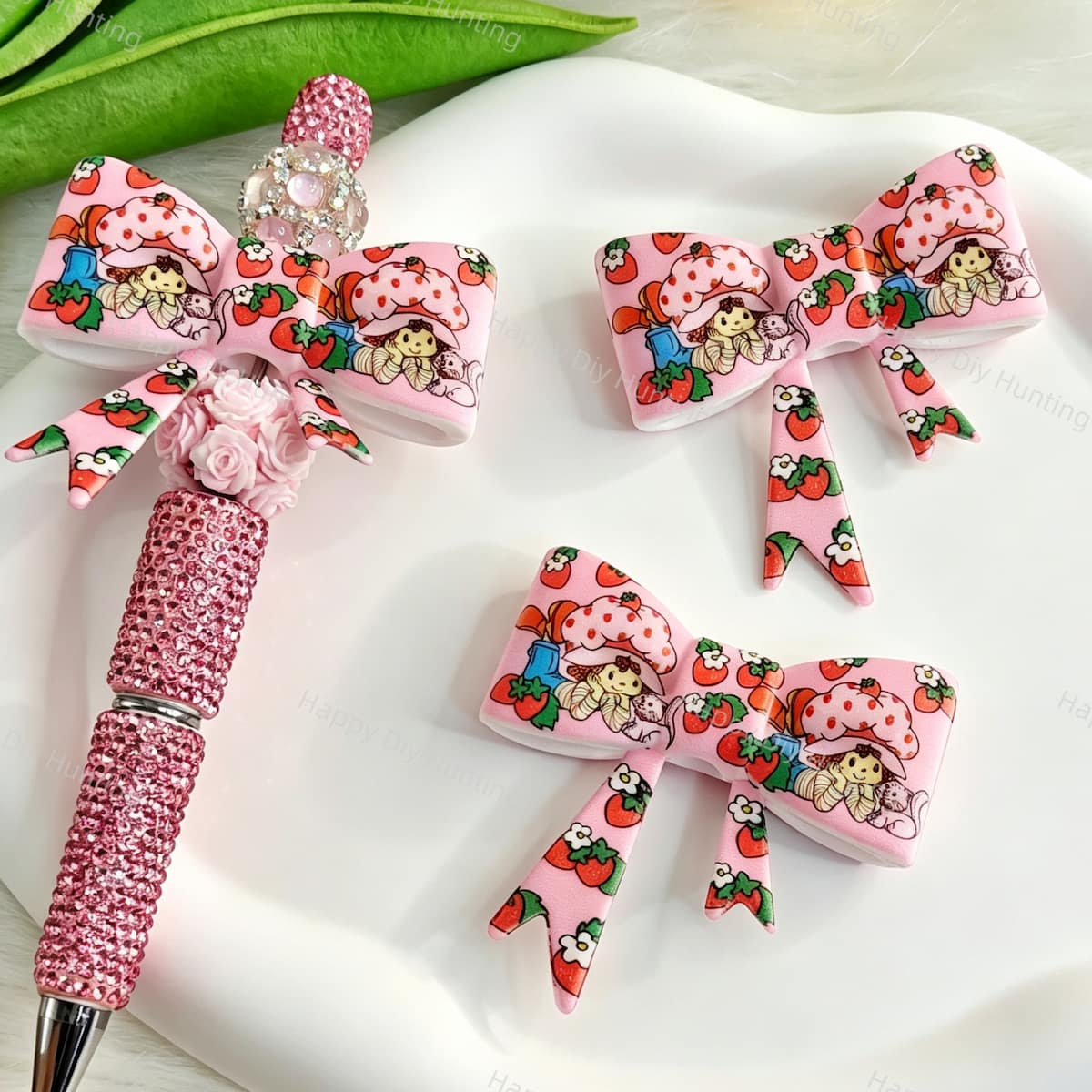Bow-shaped silicone focal beads featuring a pink cute strawberry girl cartoon design. Soft, durable, and flexible, perfect for beadable pens, keychains, and handmade crafts.
