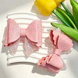 Pink layered glitter bow beads featuring an embossed V*L print design. Lightweight, sparkly, and smooth, perfect for beadable pens, keychains, and handmade crafts.